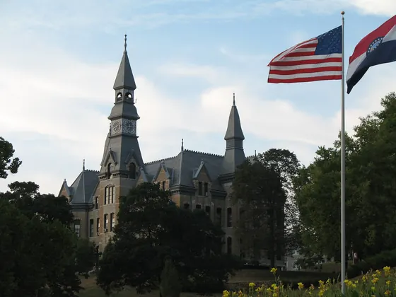 Mackay Hall, a stone Victorian building with a clock tower, at Park University in Parkville, Missouri