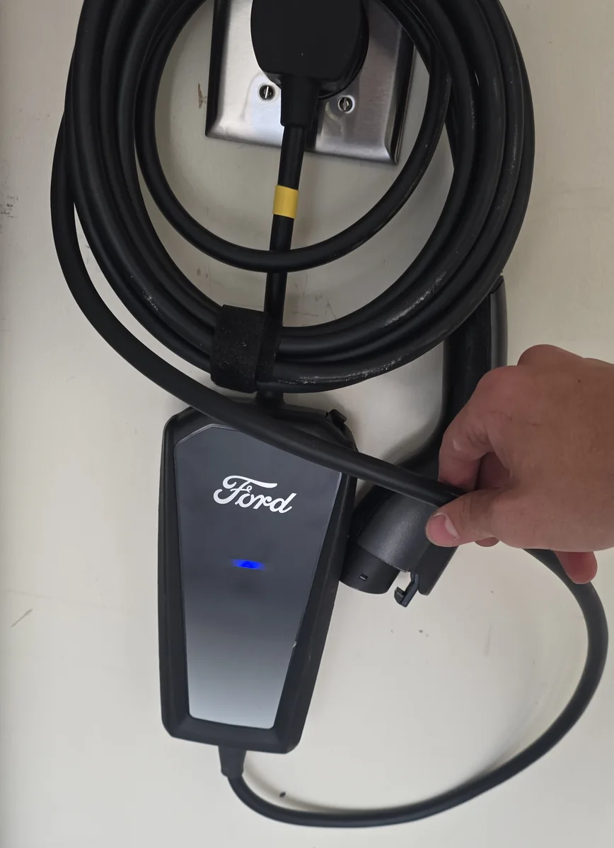 A charger plugged into a NEMA 14-50 outlet on a dedicated 240 volt circuit