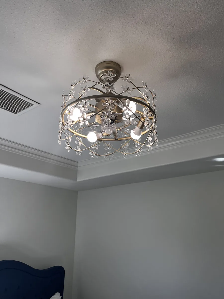 A crystal flush-mount light fixture in a tray ceiling
