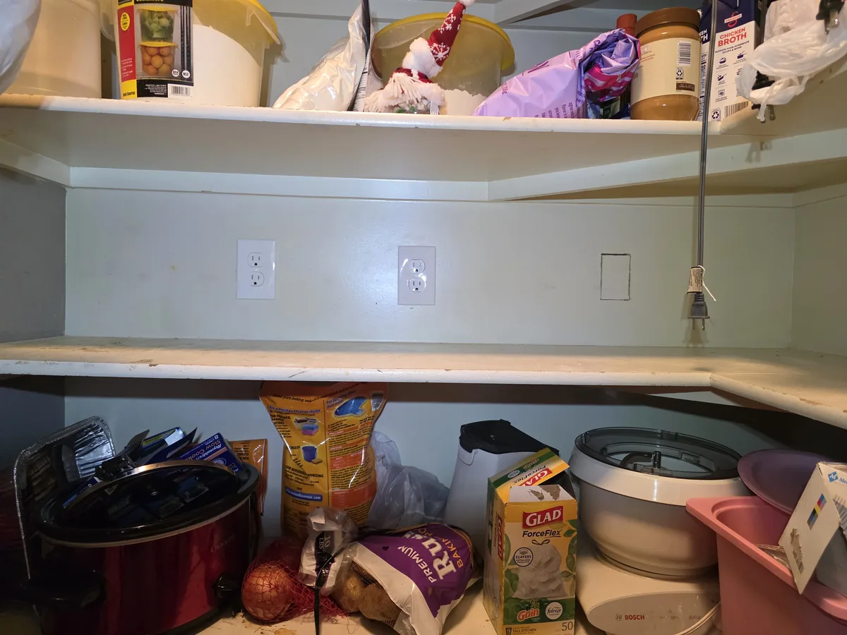 Two new receptacles installed along a pantry wall between shelves