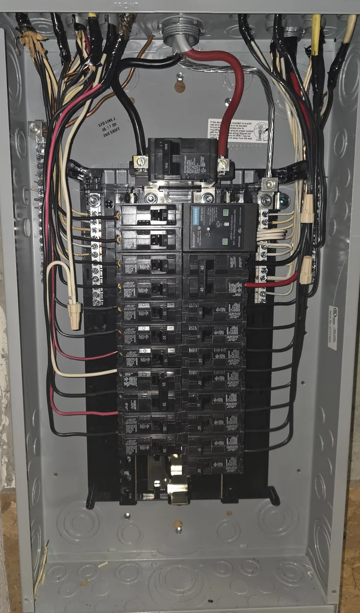 The replacement panel, with a whole-home surge protector showing green